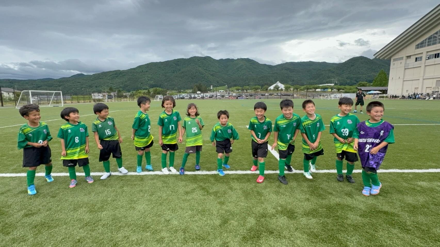 会津の山並みを背に整列する会津サントスFCの子どもたち